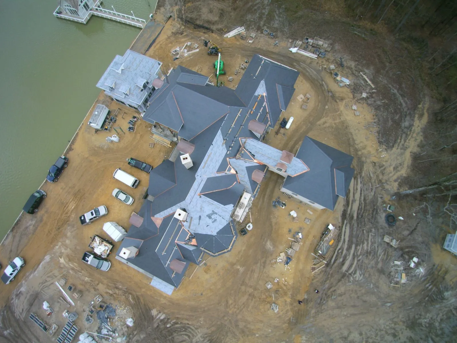 An aerial view of a large estate roof replacement in progress